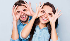 Couple using hands to accentuate their eyes
