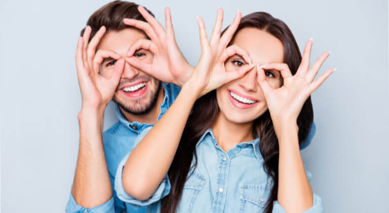 couple using hands to accentuate their eyes