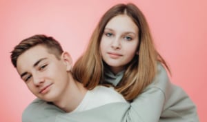 Two teenagers in romantic embrace