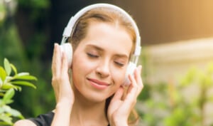 Woman wearing headphones listening to audiobook